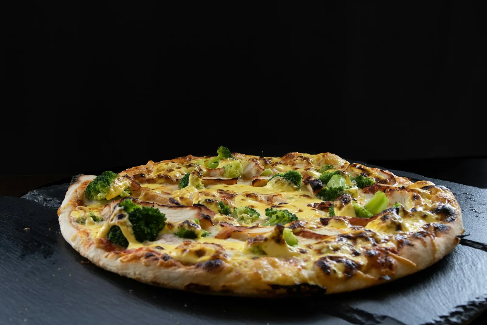 A pizza on a dark background