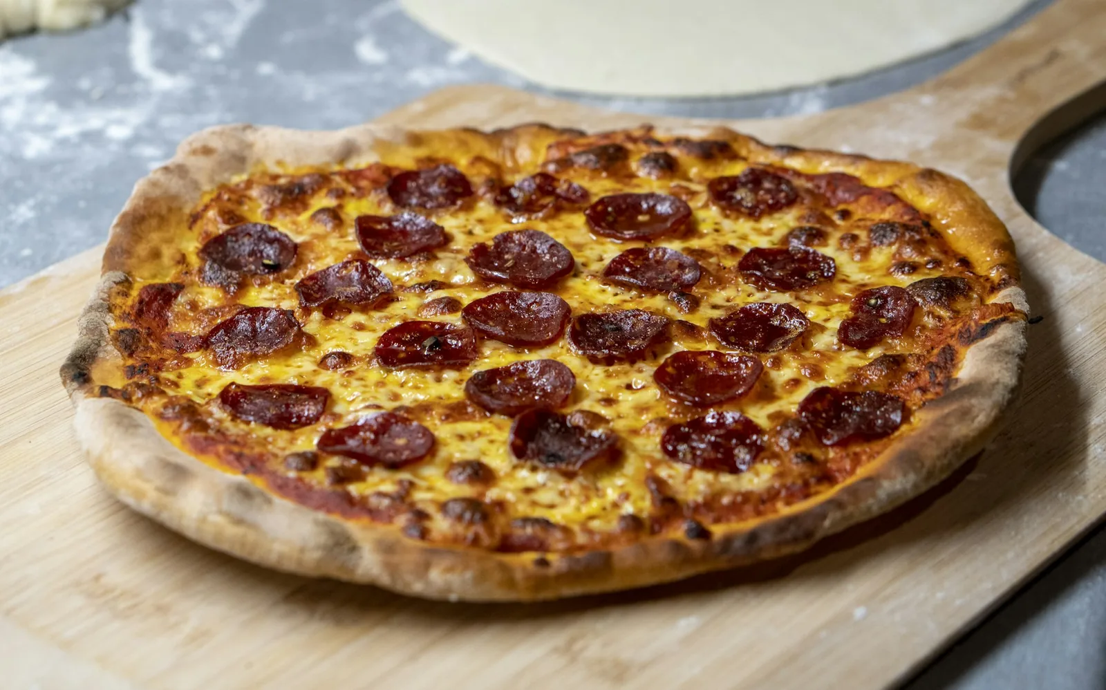 A meat pizza on a board