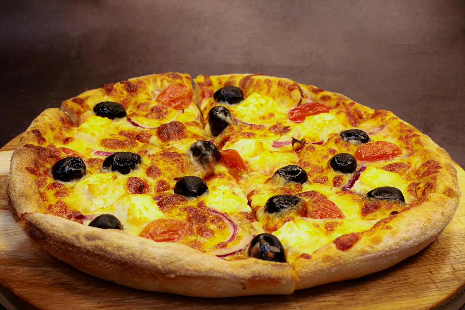 A pizza on a dark surface