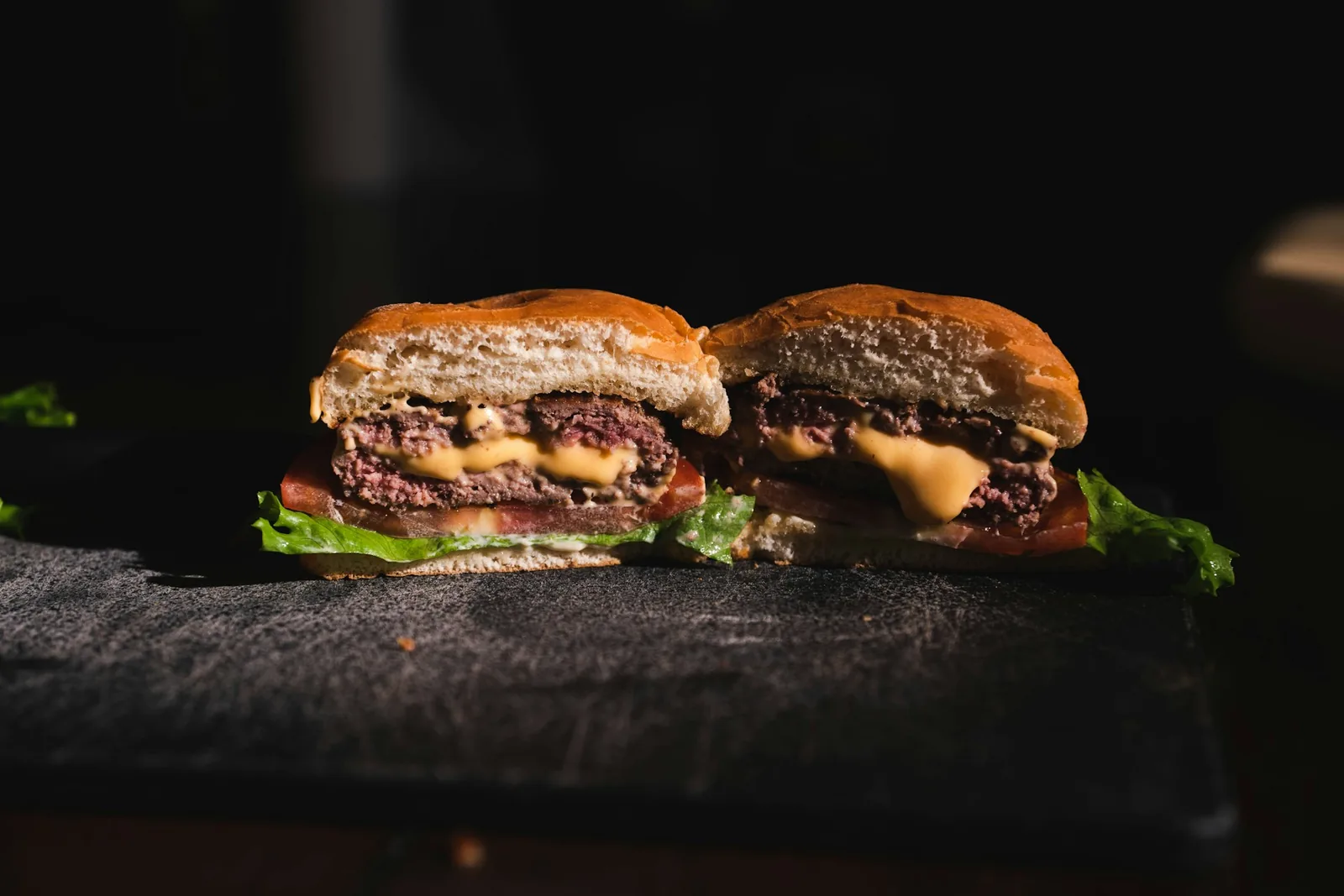 A cheeseburger cut in half