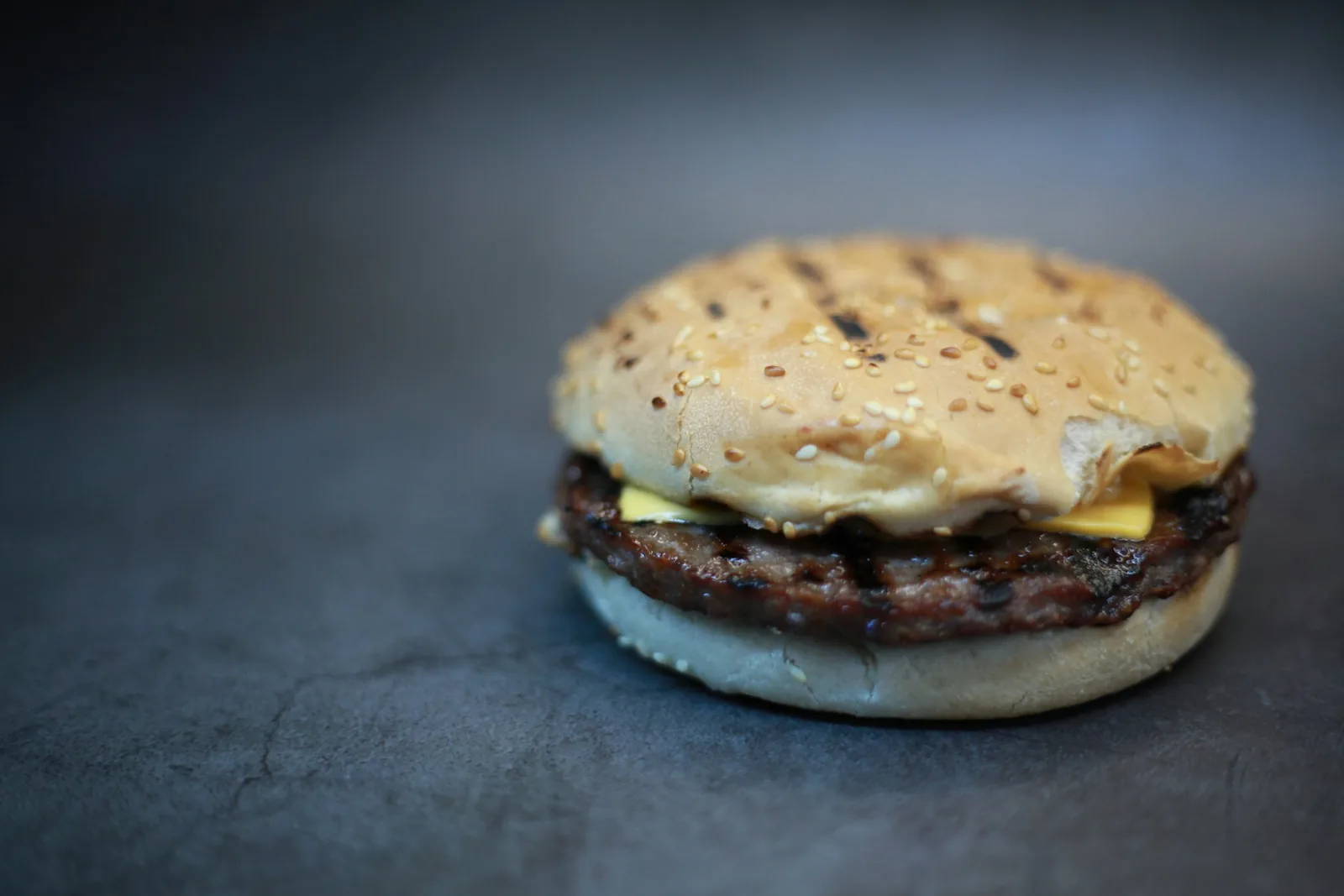 A cheeseburger on a dark background