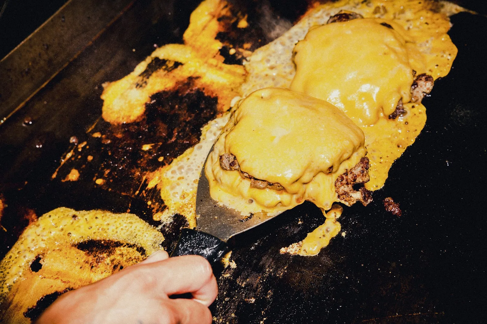 Cheese melting over a patty
