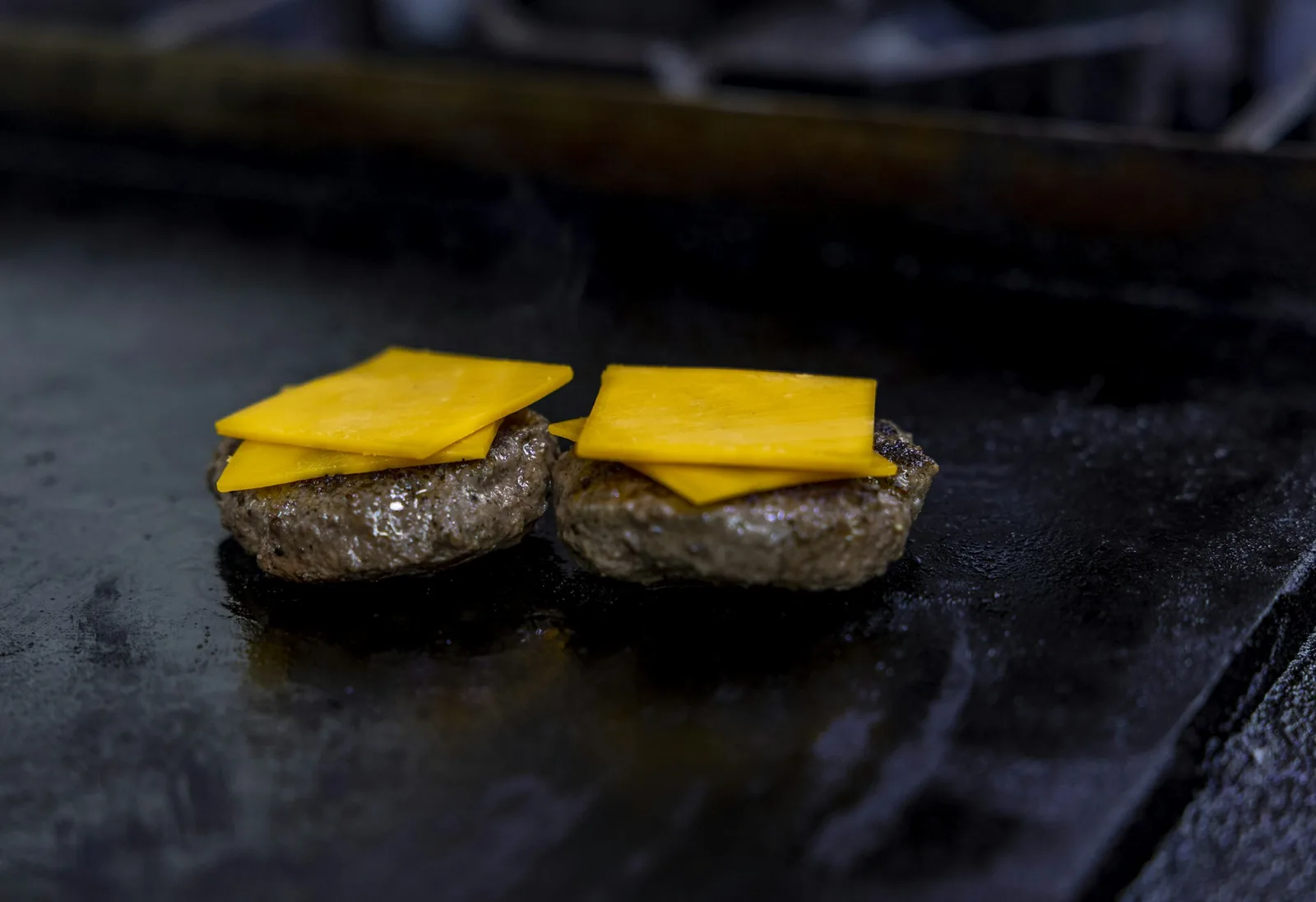 Cheese melting over cooked meat