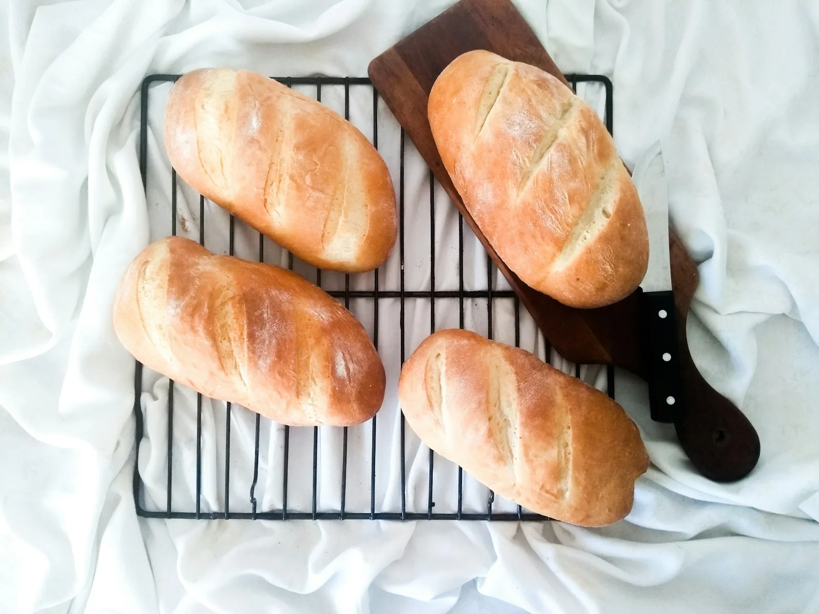 Long bread rolls on a rack