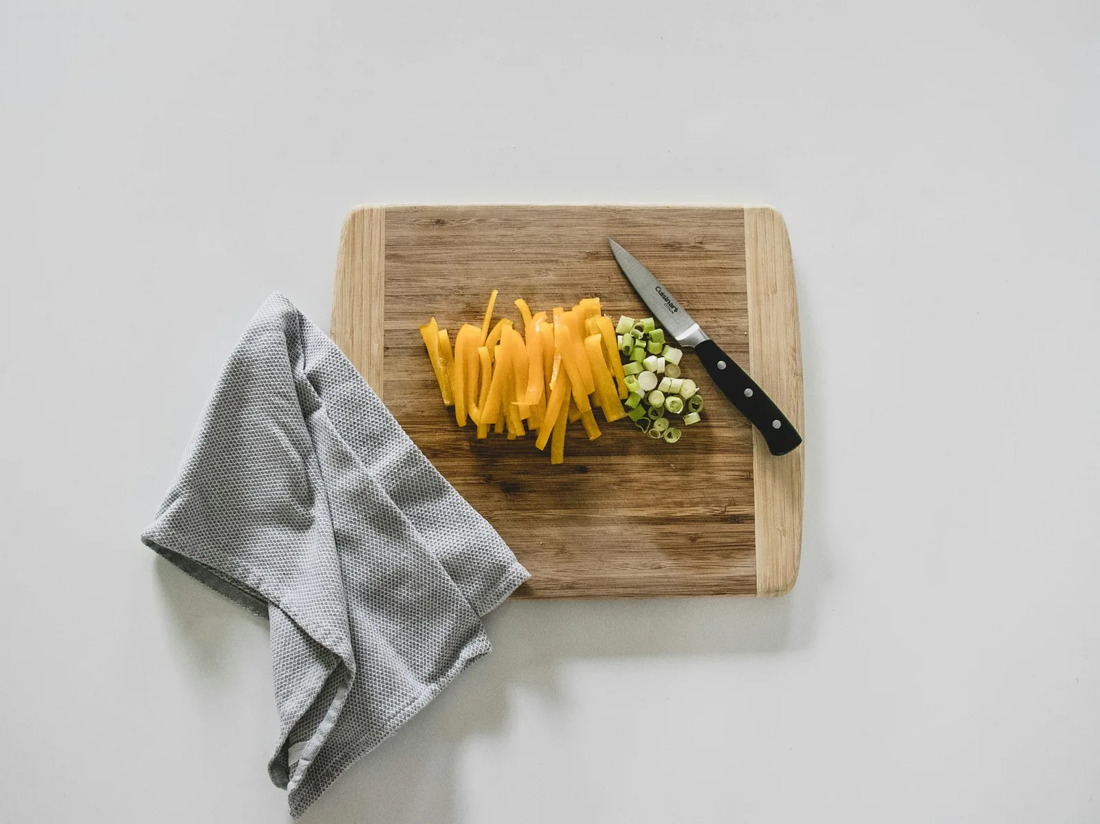 Sliced yellow peppers on a board