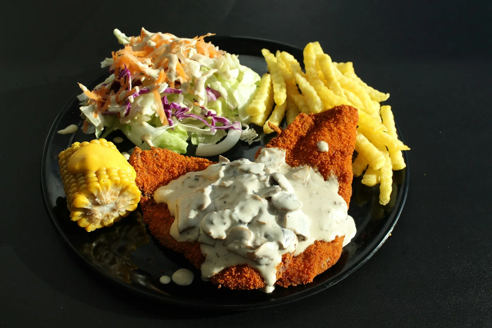 A breaded chicken cutlet served with sides