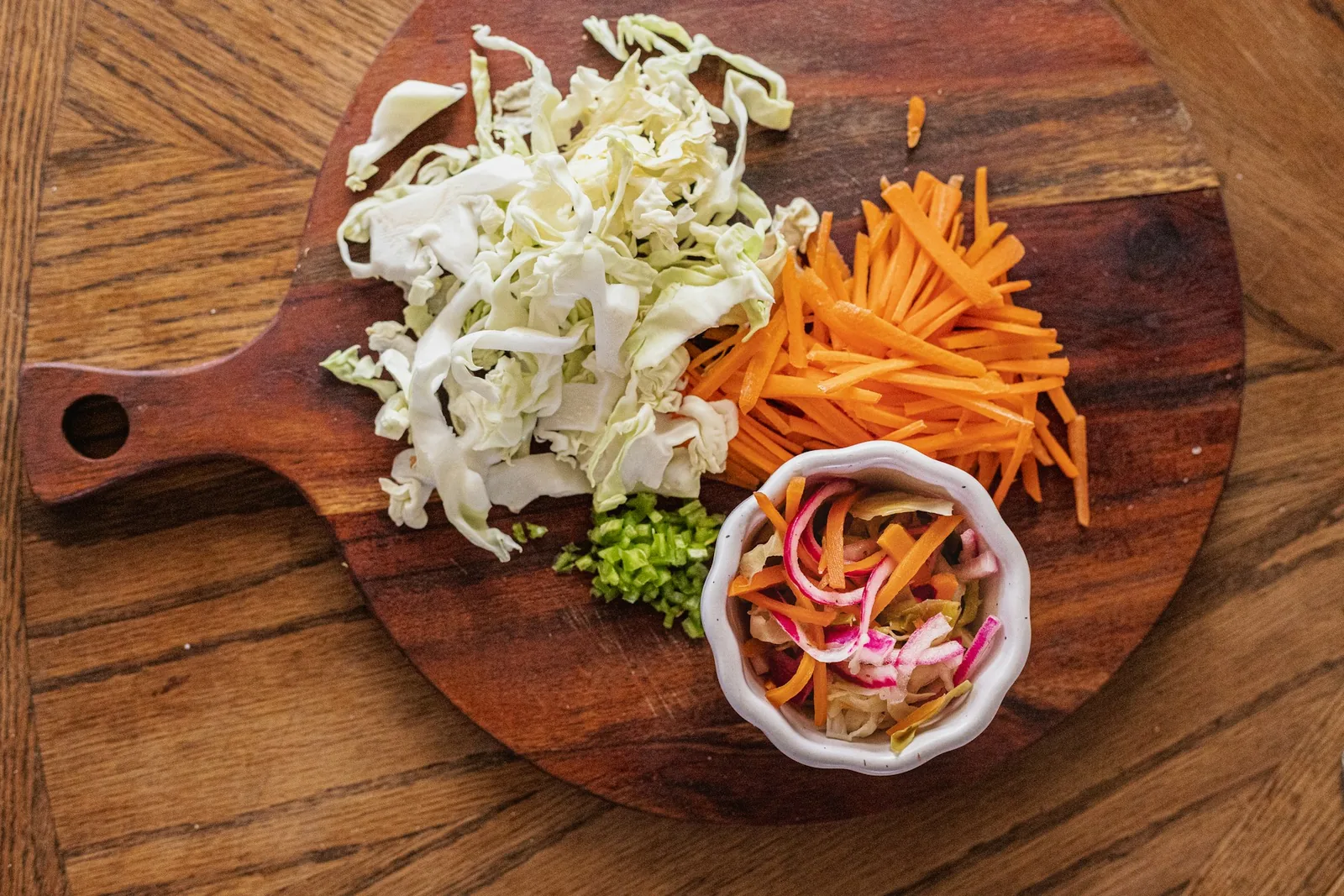 Shredded cabbage and carrot on a board