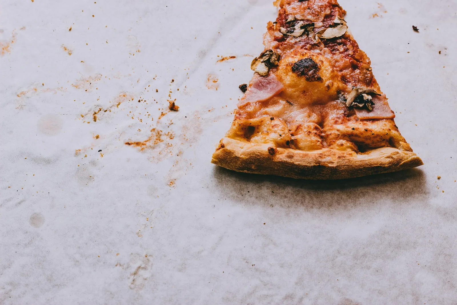 A pizza slice on a dark background