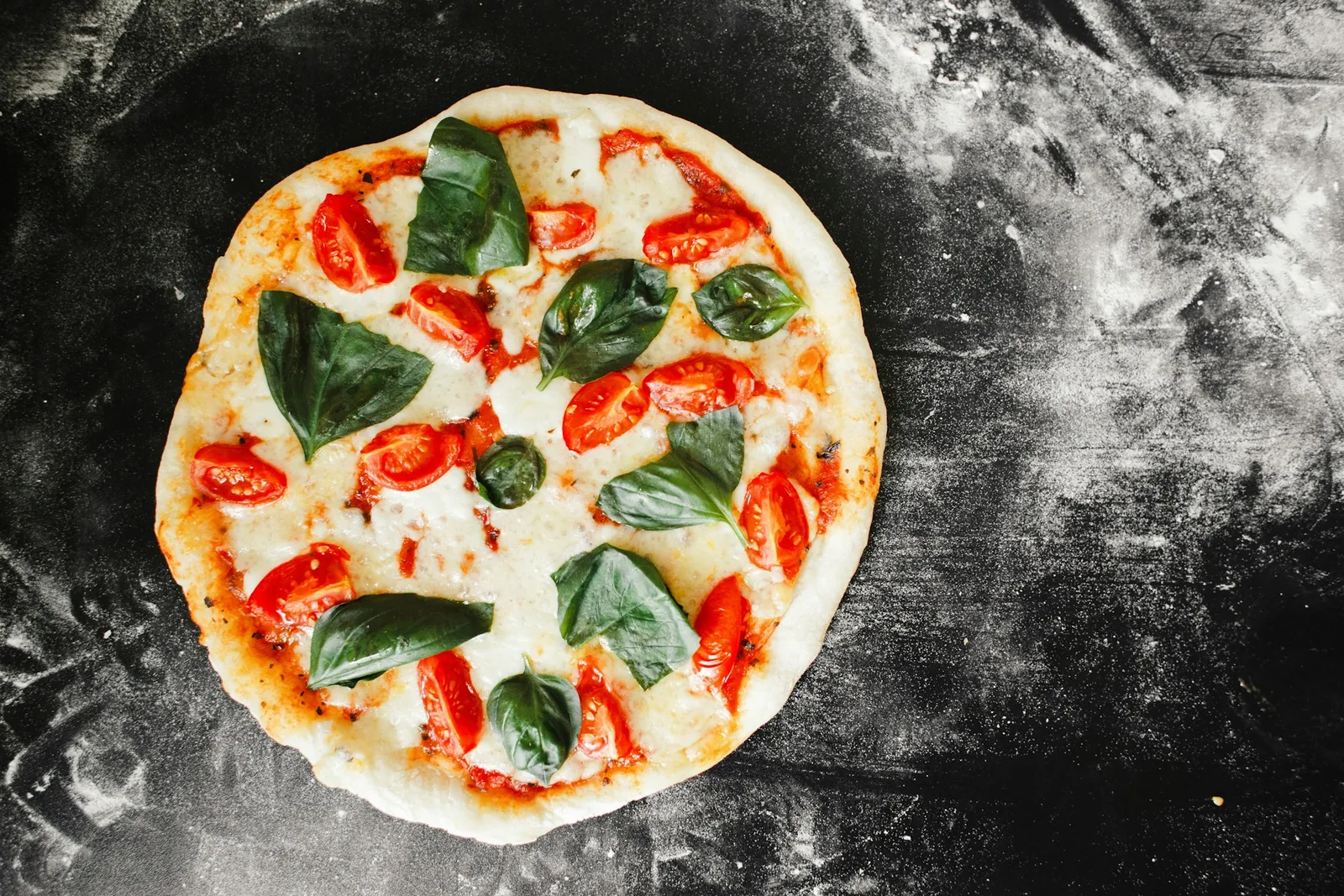 A whole pizza on a dark background