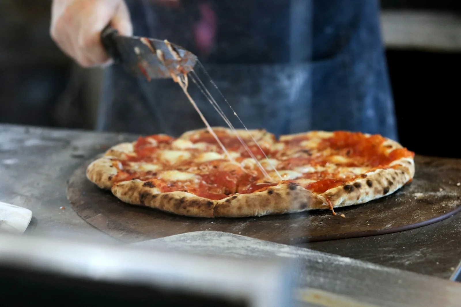 A pizza being topped