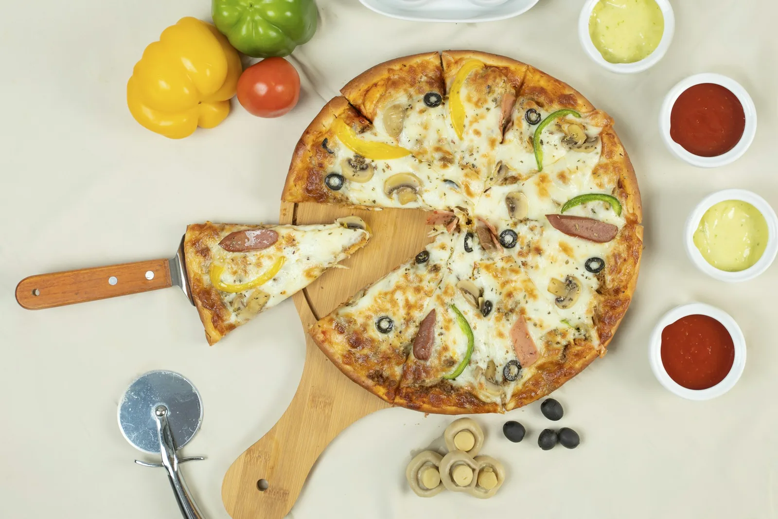 A pizza with a slice lifted out