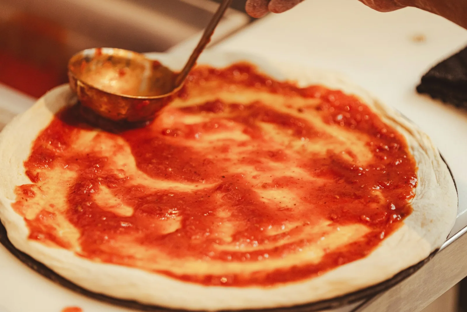 A thin layer of sauce on dough