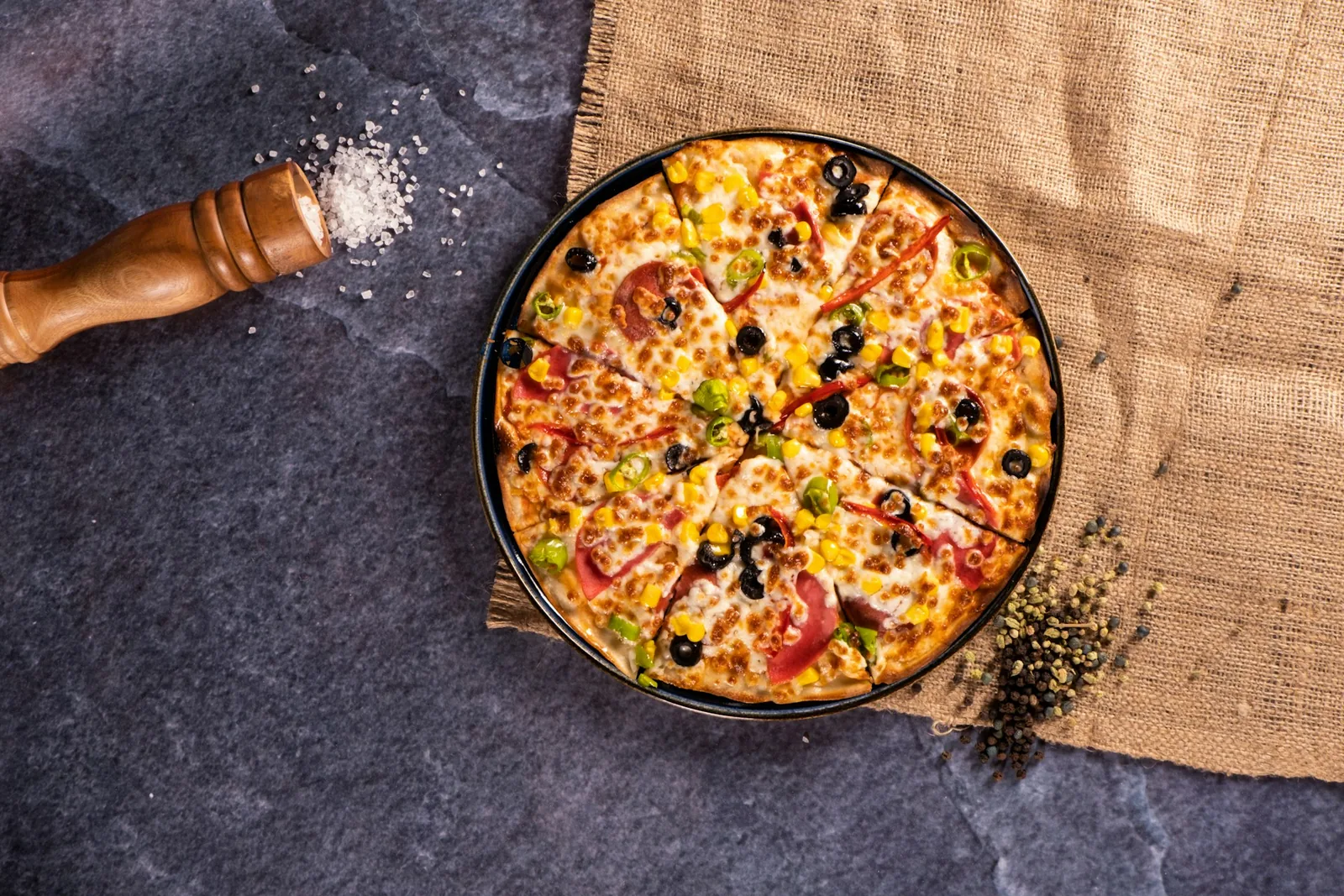 A pizza on a dark surface
