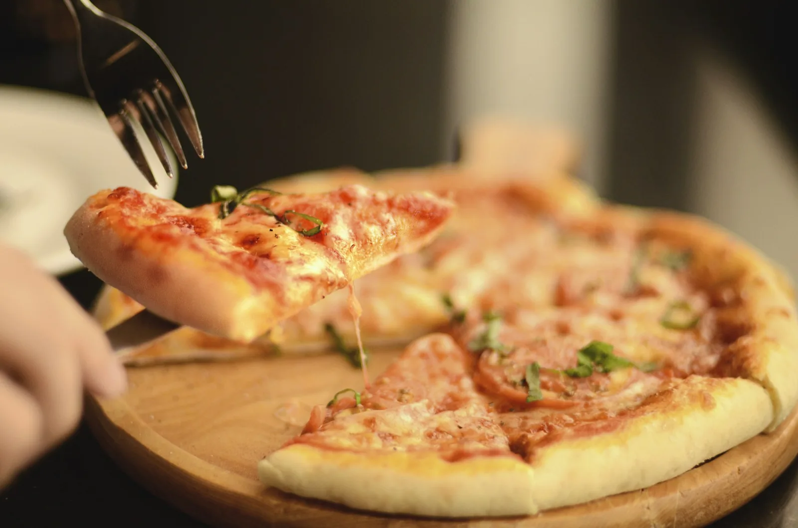 A slice of pizza being lifted