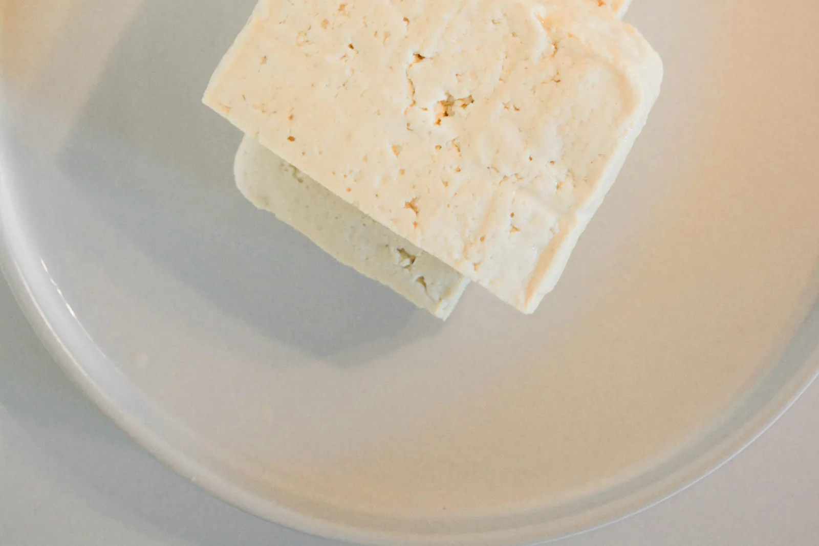 A block of pale cheese on a plate
