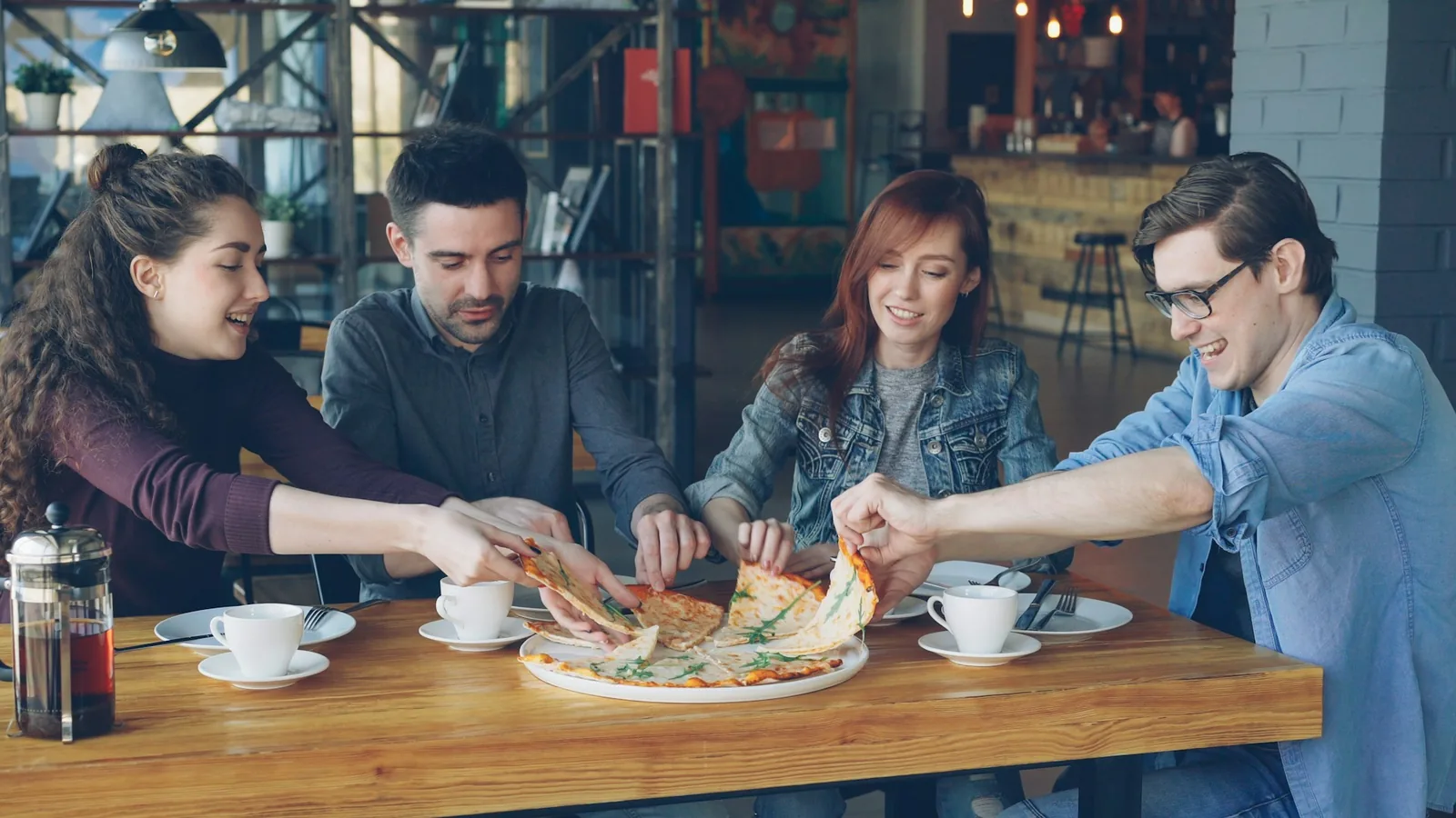 People sharing slices at a table