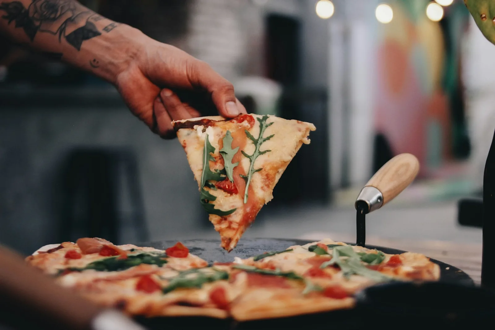 A pizza slice held in one hand