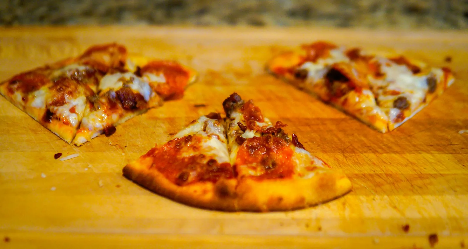 Slices of pizza laid out on a board