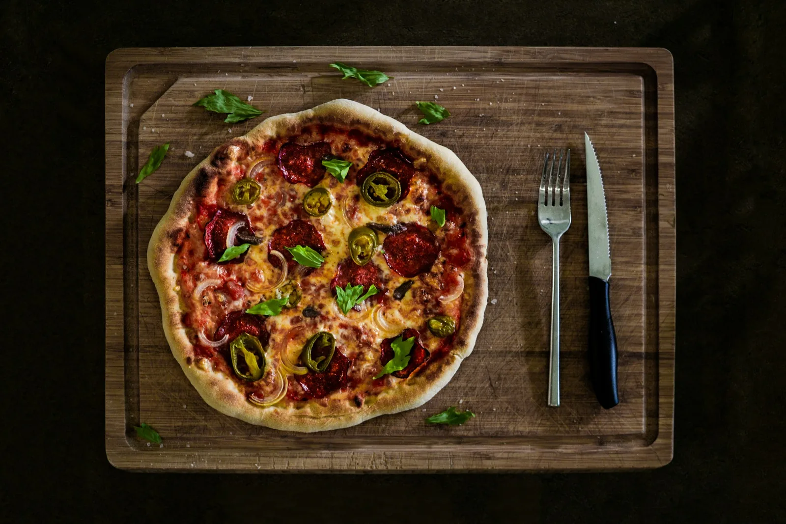 A whole pizza on a serving board