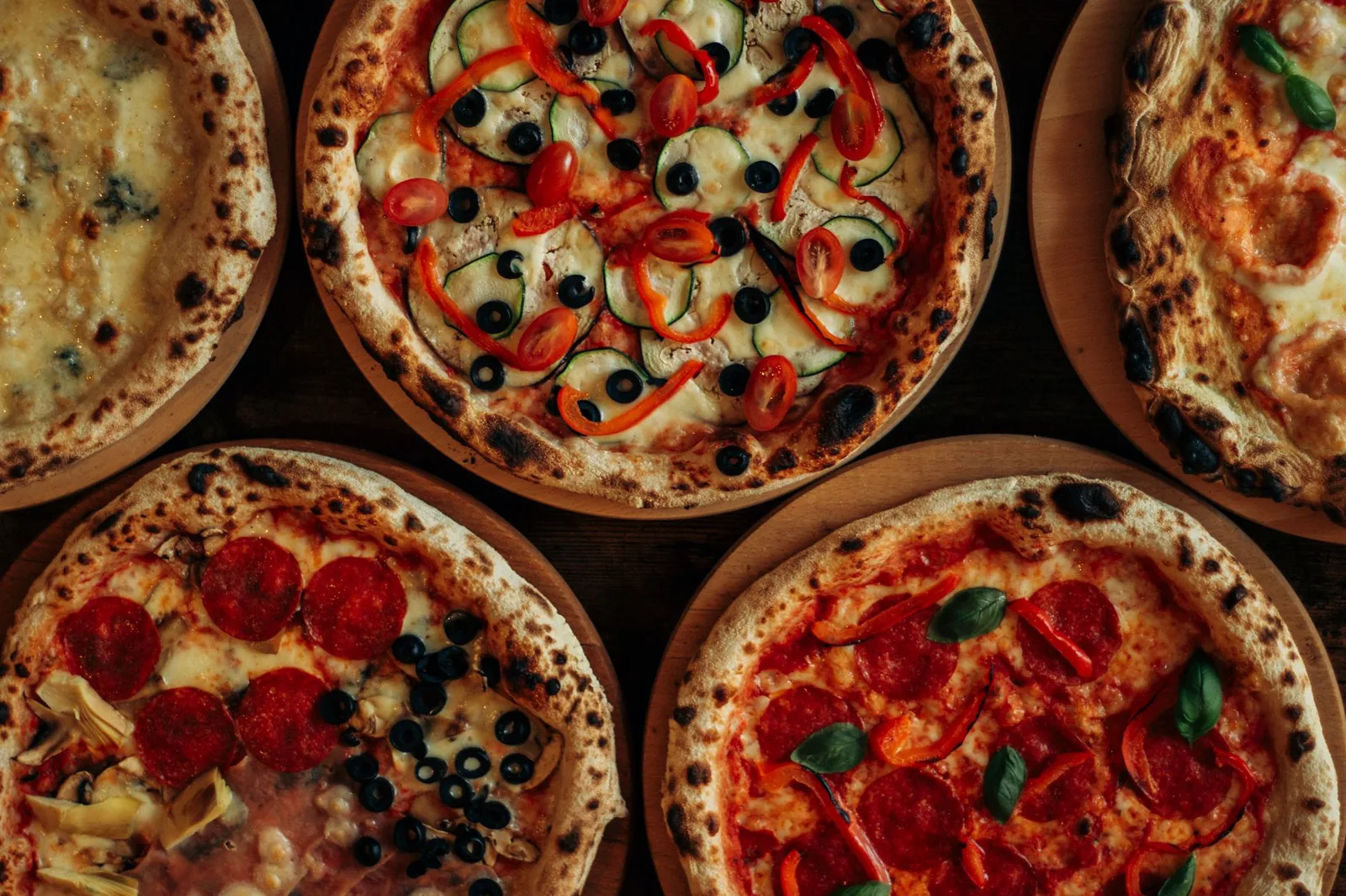 Several pizzas side by side