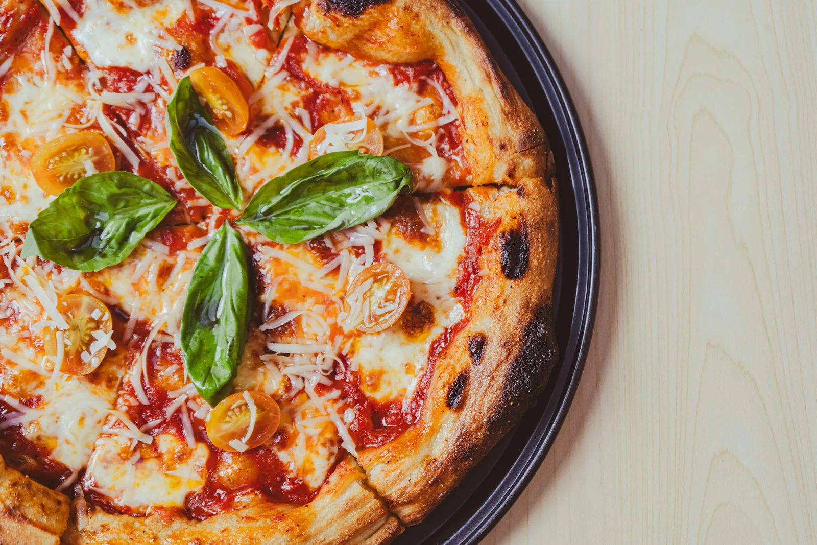 A pizza on a table in warm light