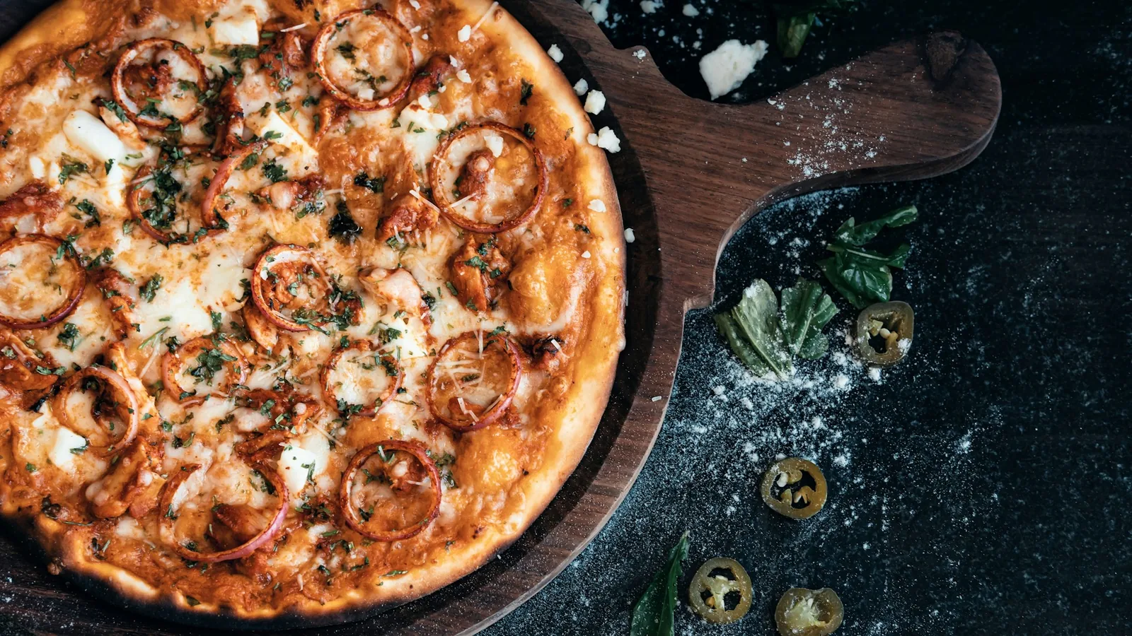 A pizza on a dark surface