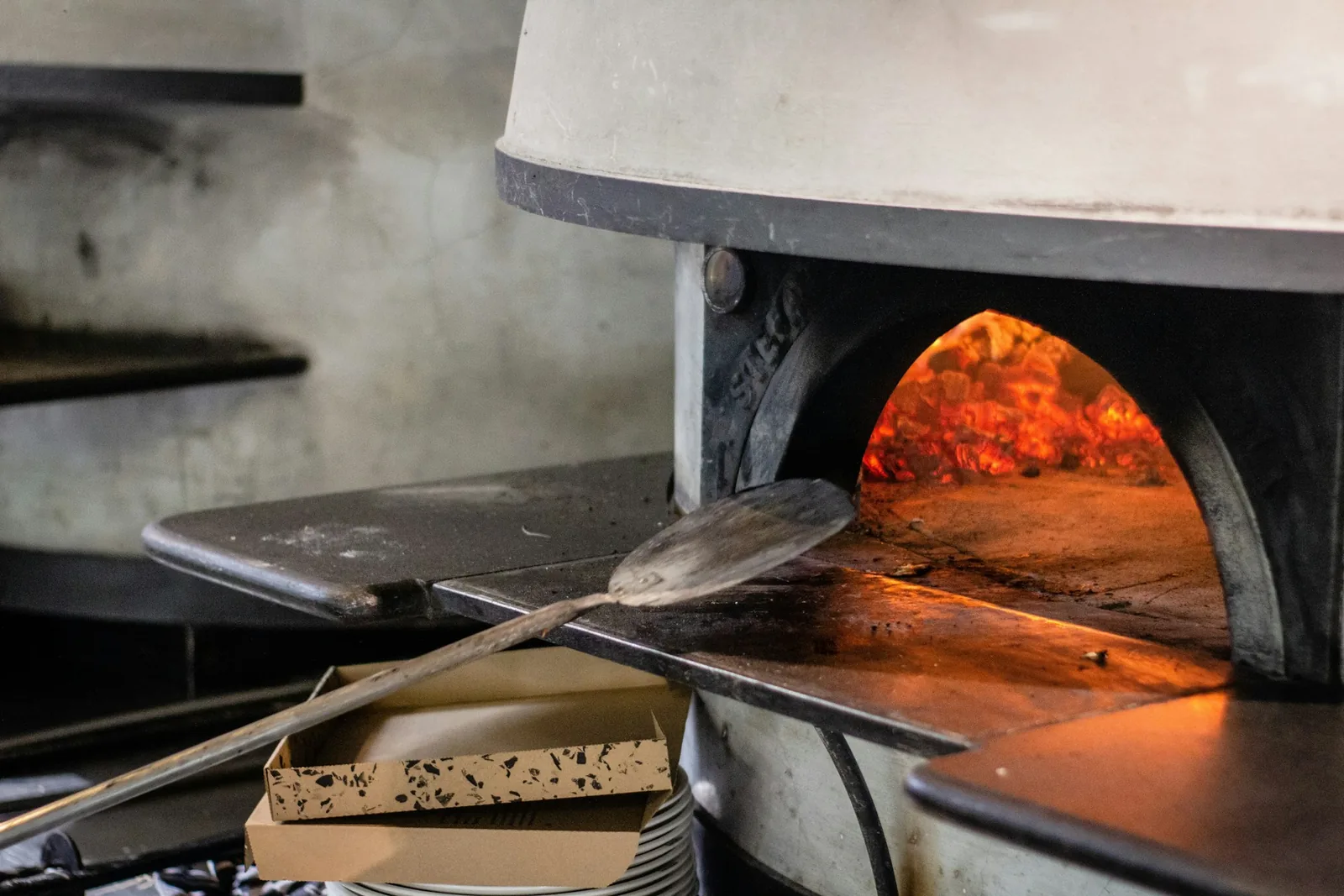 A pizza going into the oven