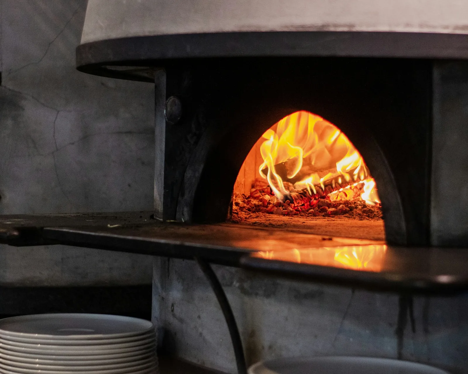 Fire burning inside a pizza oven