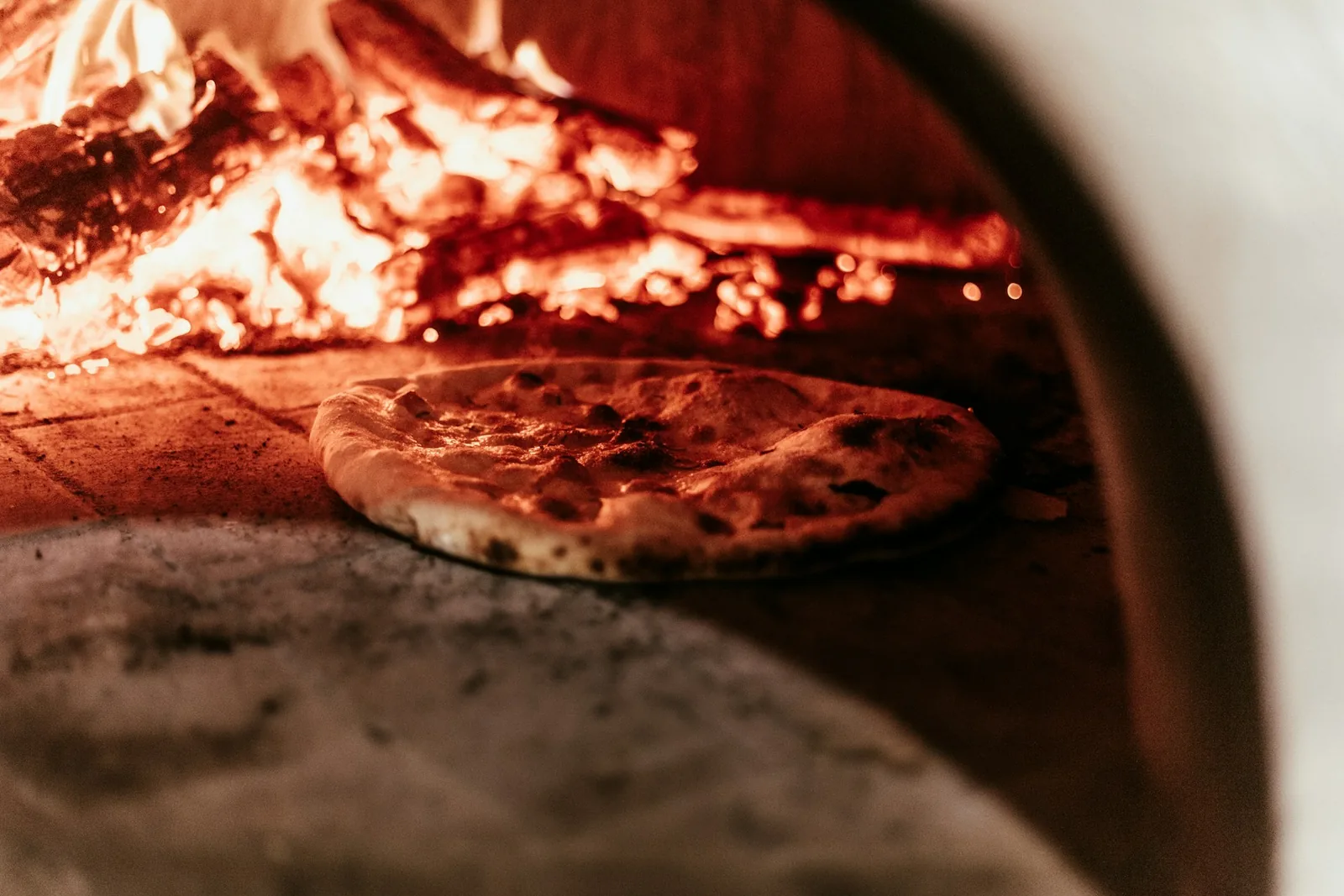 A pizza going in on a peel
