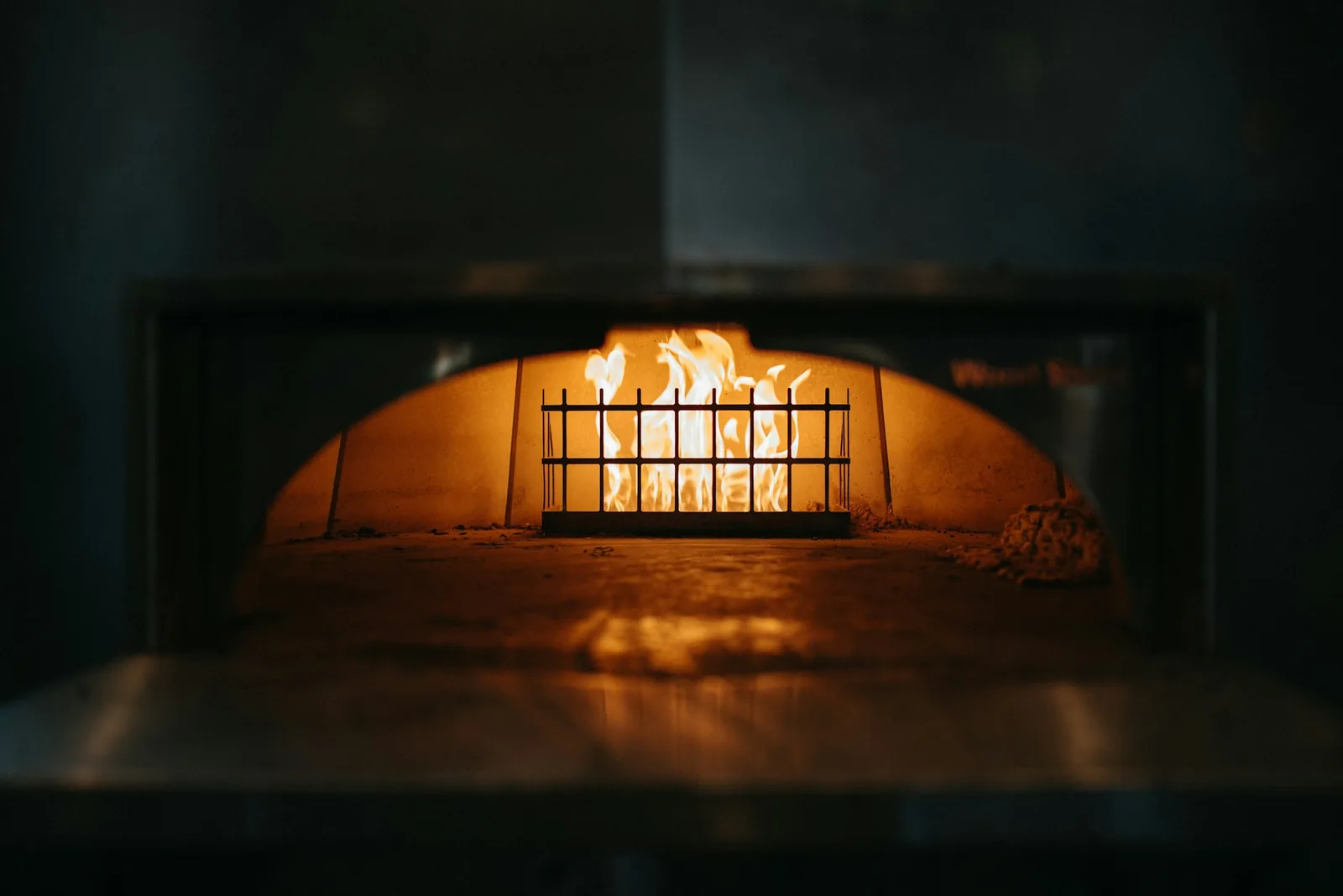 The lit mouth of a pizza oven