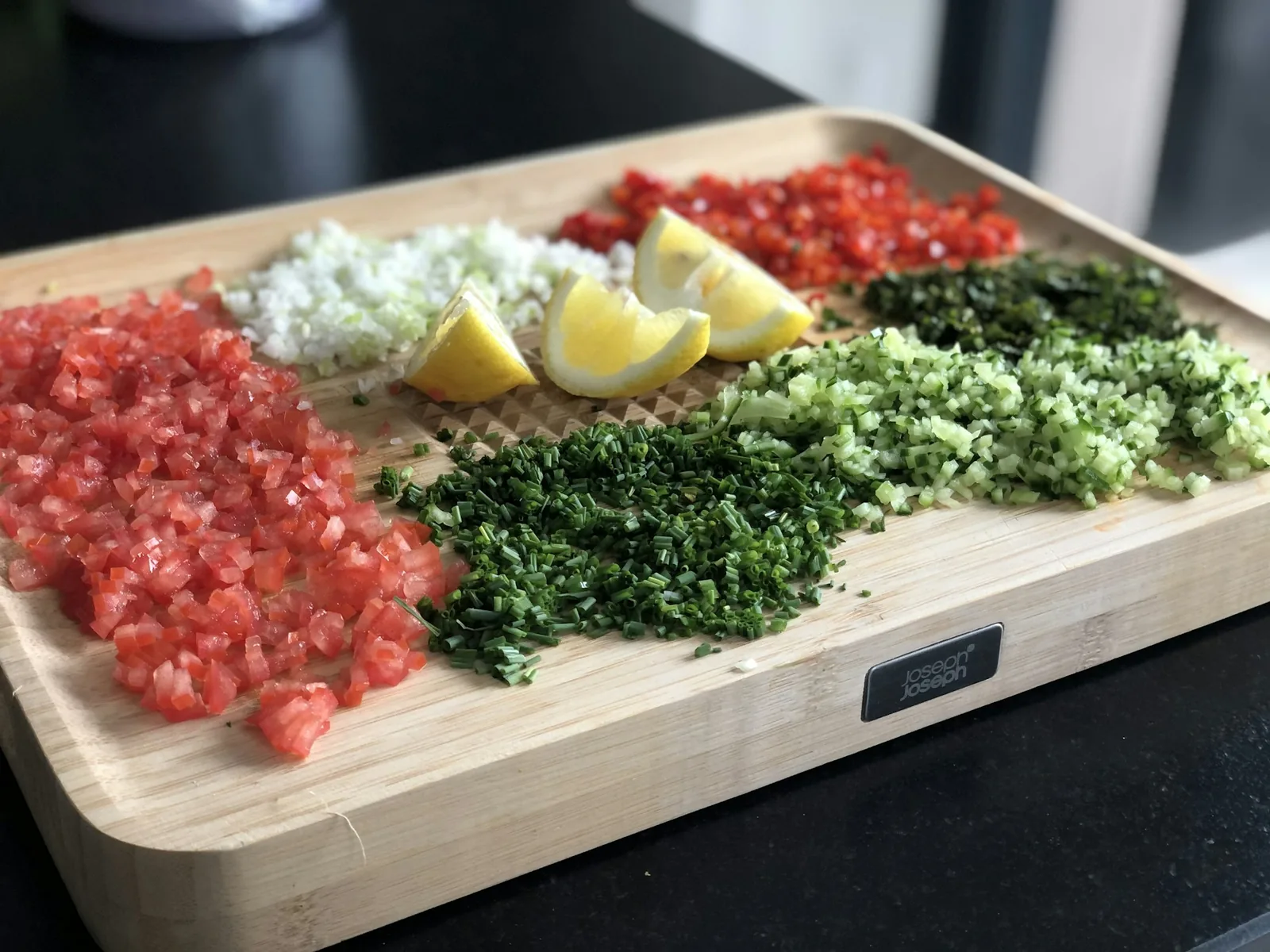 Chopped herbs and raw meat prepared on a board