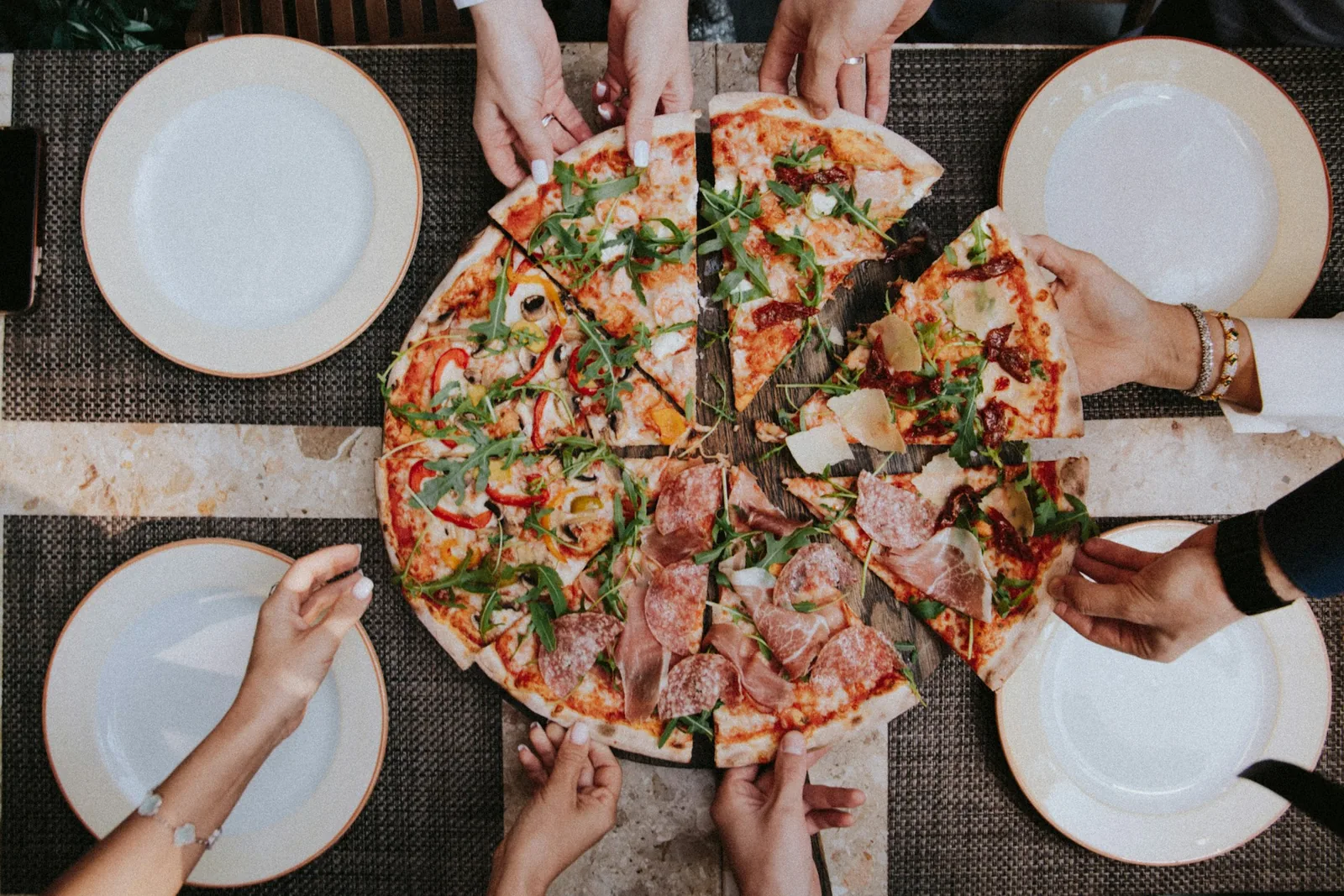 Pizzas laid out on a long table