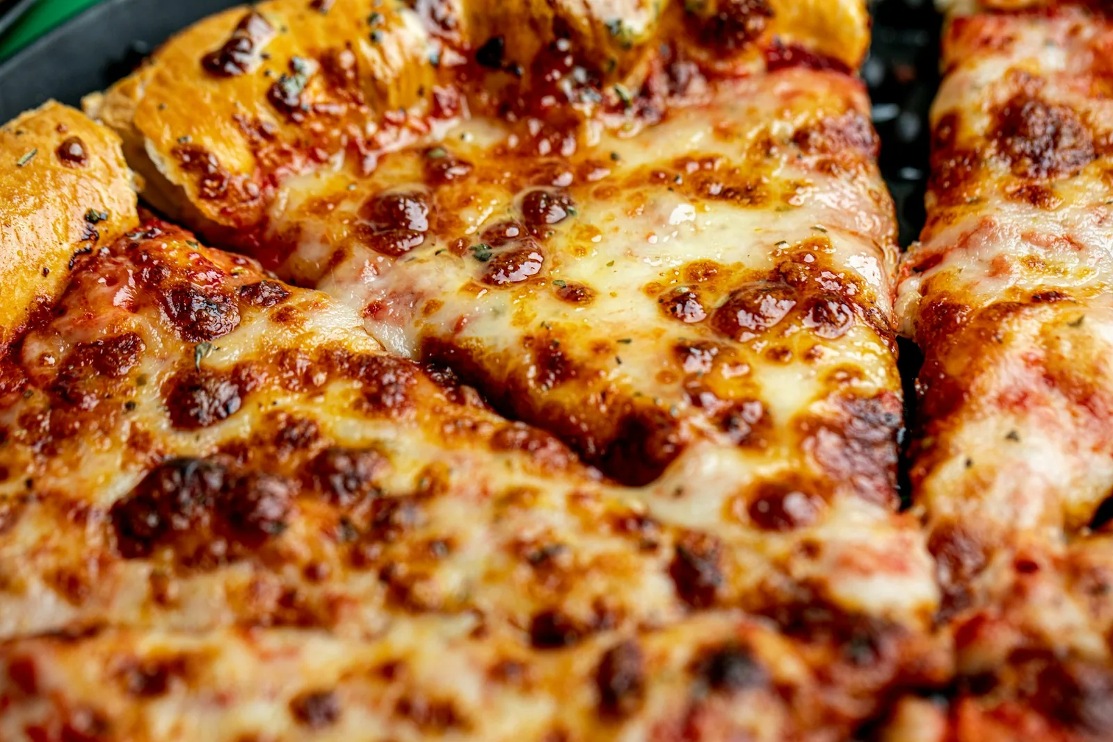 A close-up of a cheese pizza slice