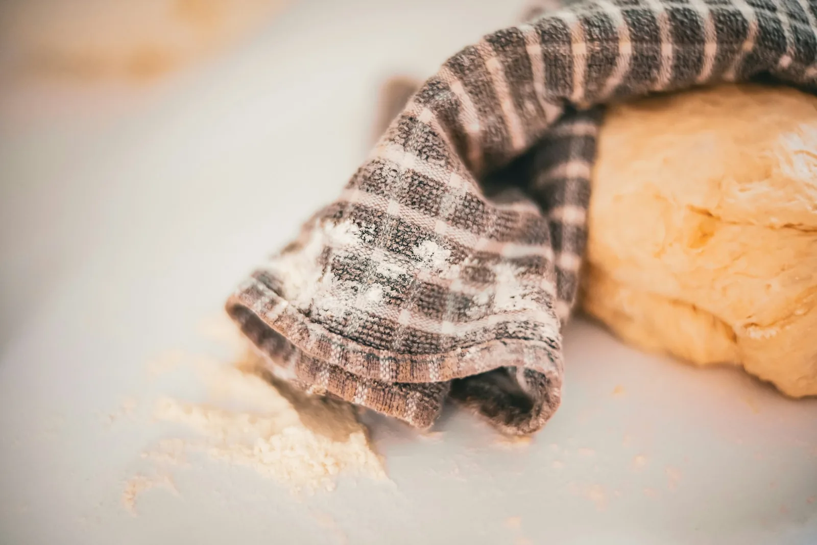 Dough resting under a cloth