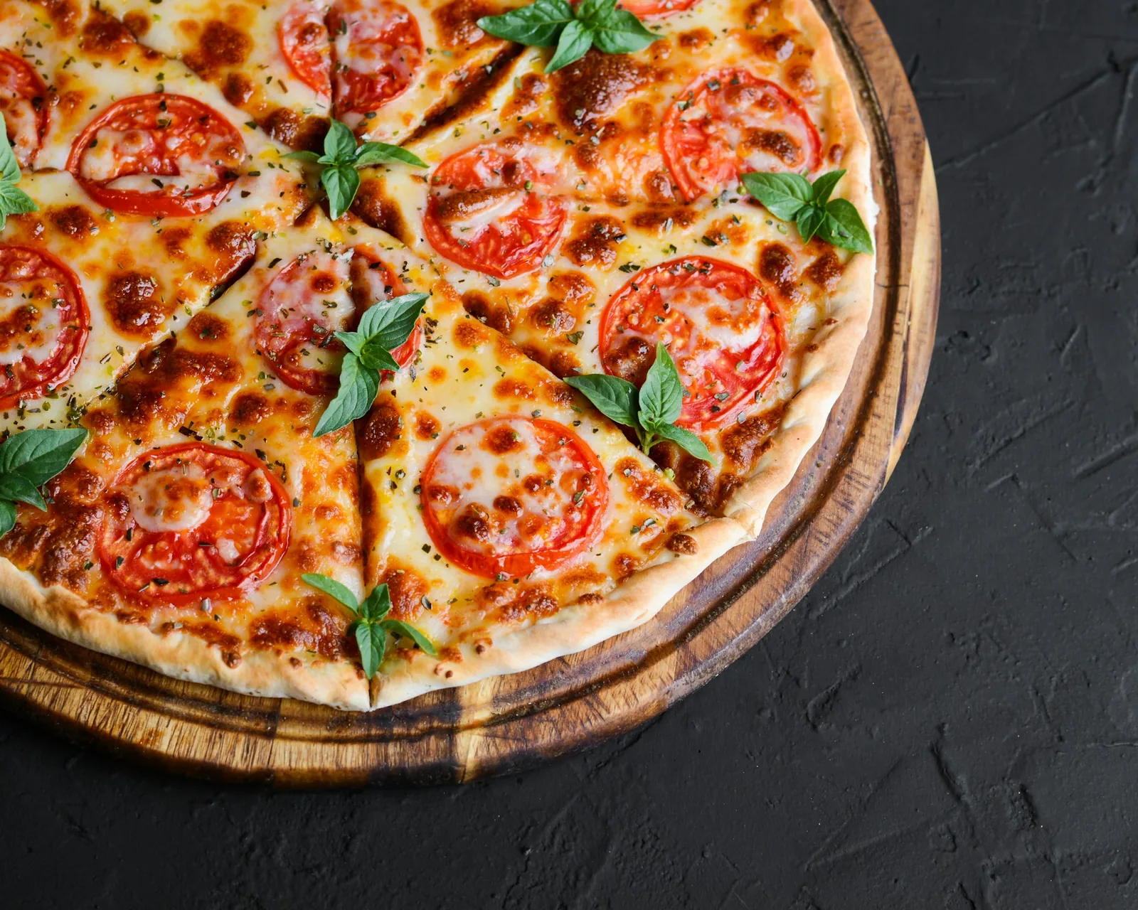 A baked pizza on a dark background