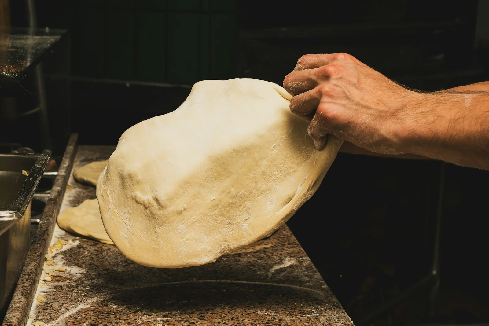 Stretching dough into a base