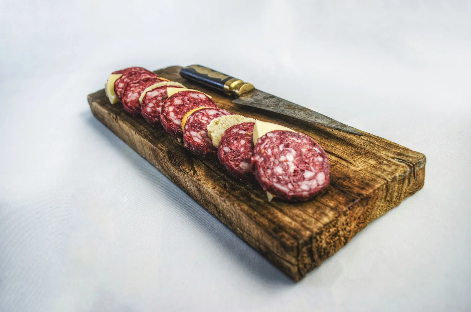 Slices of cured sausage on a board