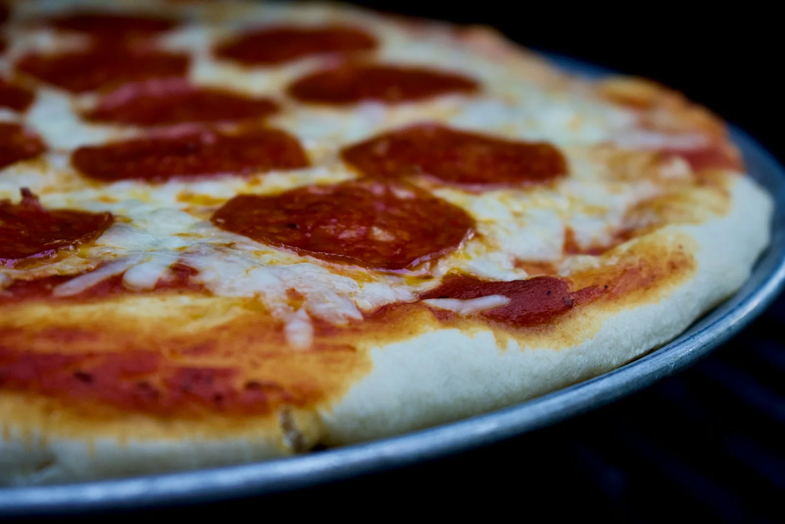 The puffed rim of a pizza crust