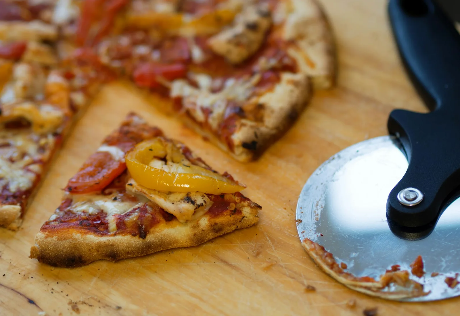 A pizza wheel on a board