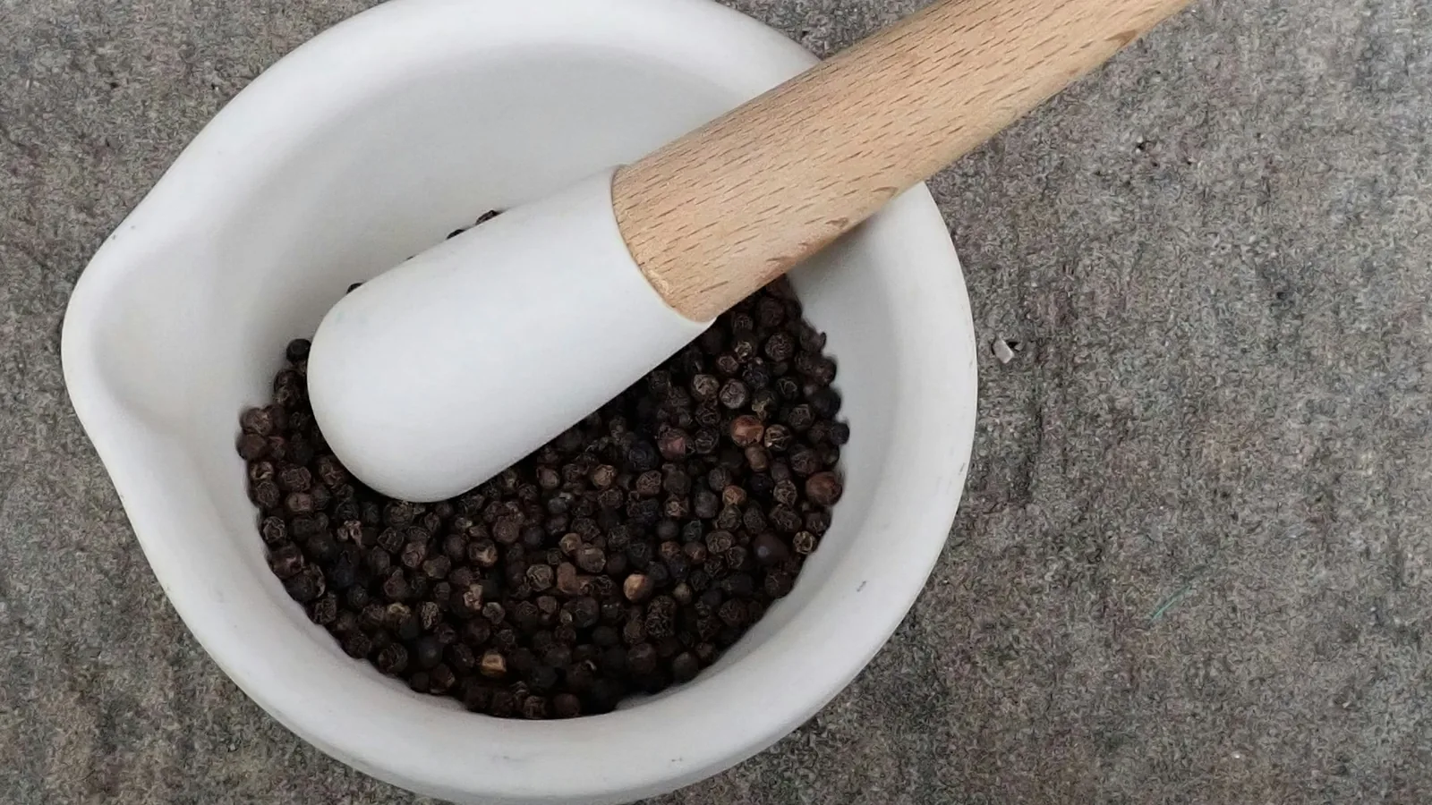 Peppercorns in a mortar and pestle