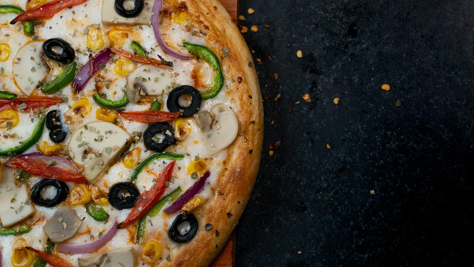 A pizza on a dark surface
