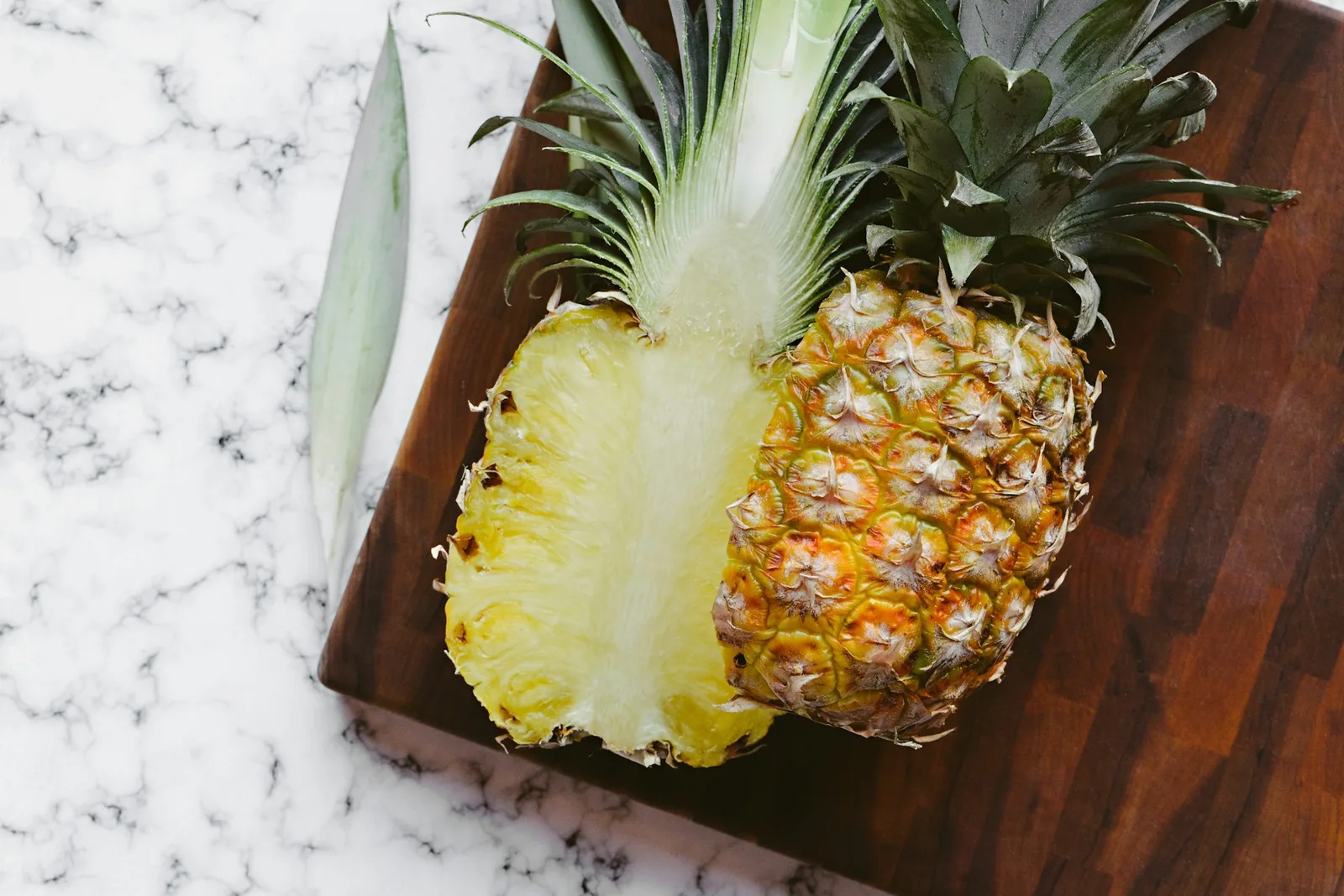 A whole pineapple cut into slices