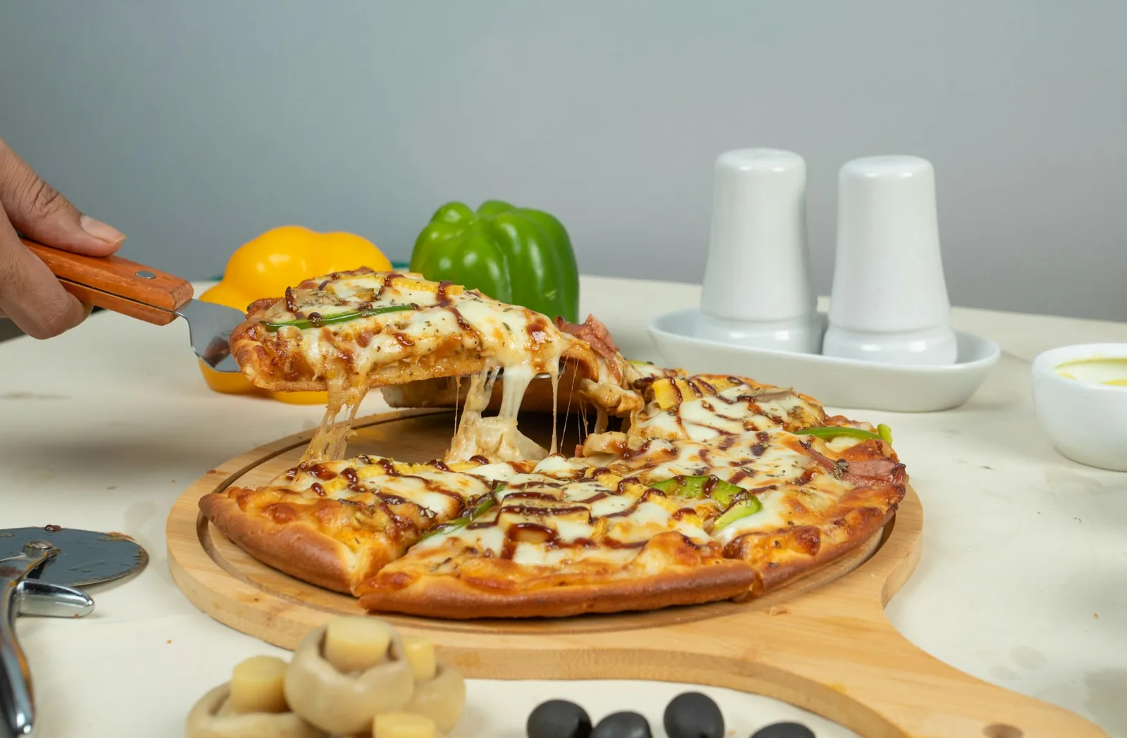A pizza being cut into slices