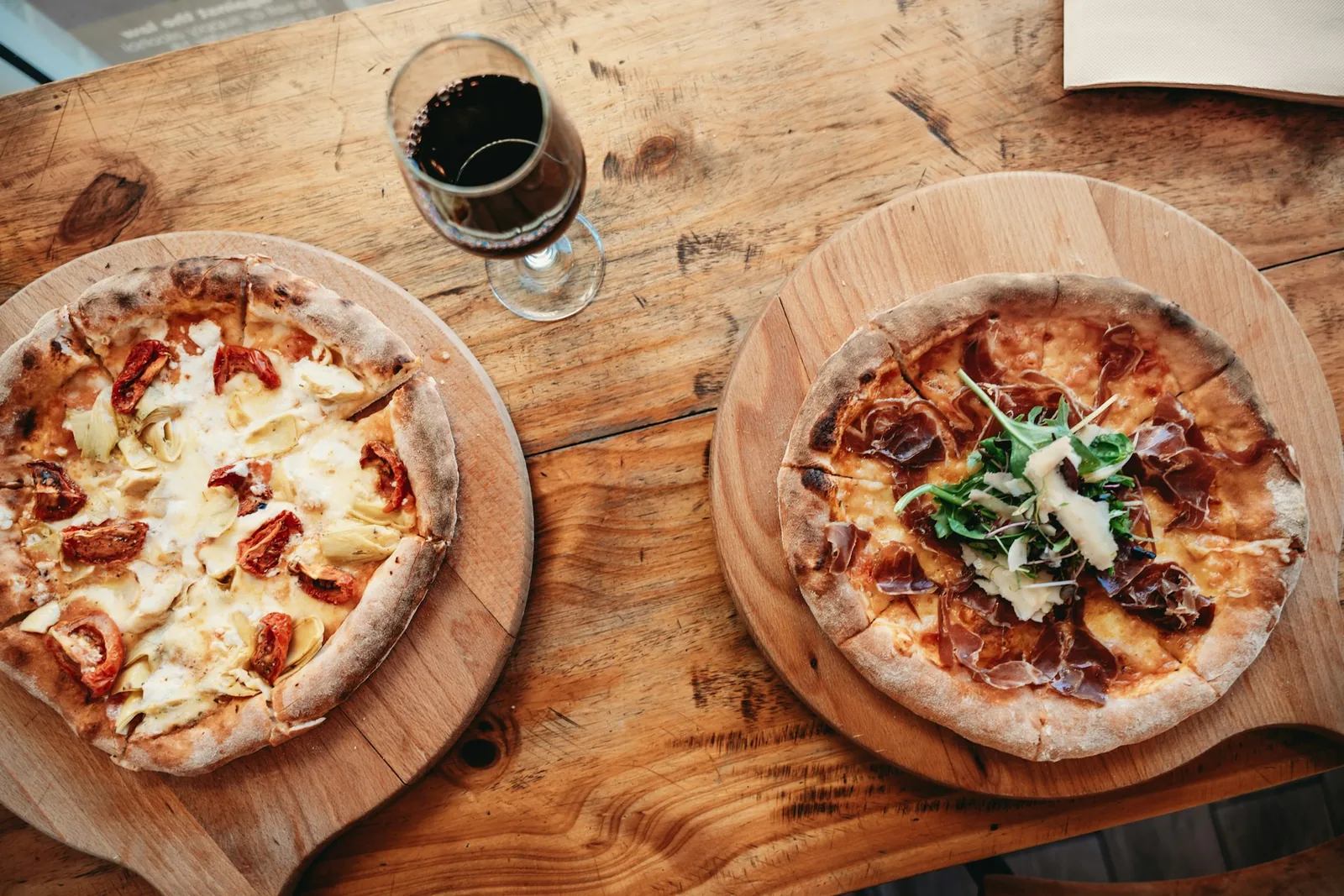 People sharing pizza around a table