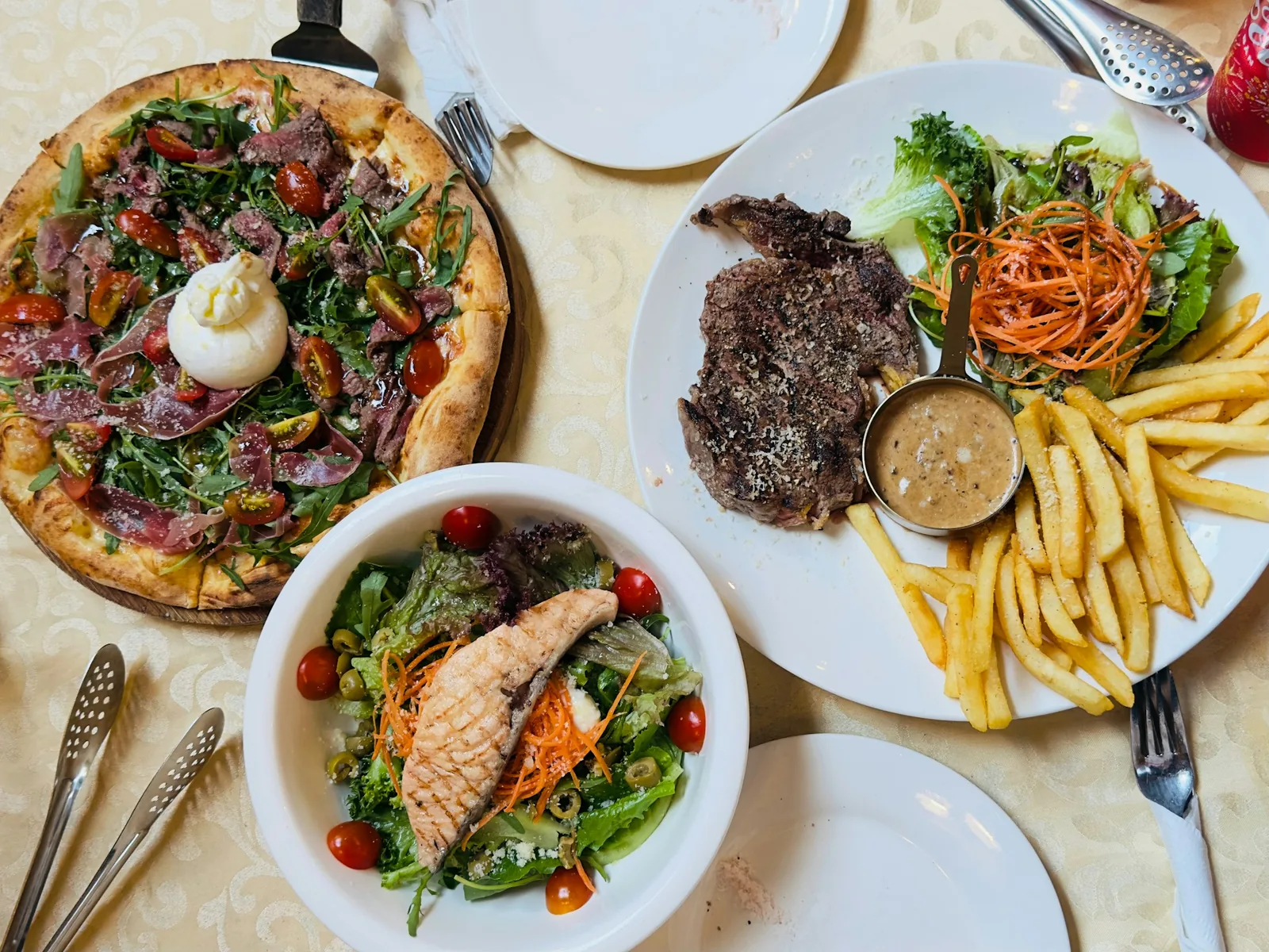 A salad served beside pizza