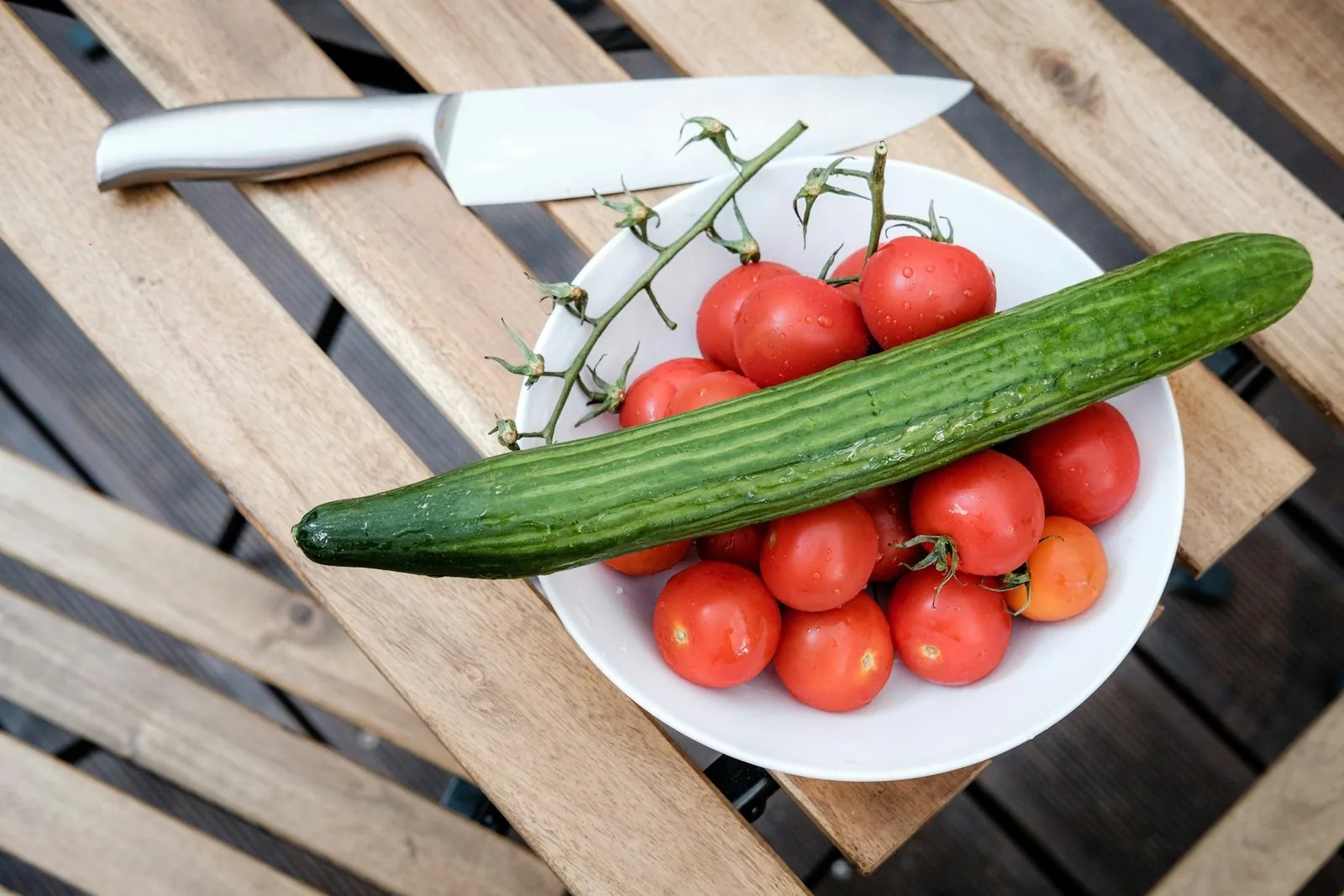 Tomatoes and a cucumber ready to prepare