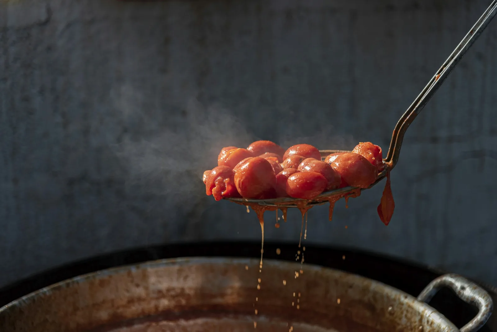 A ladle of tomato sauce