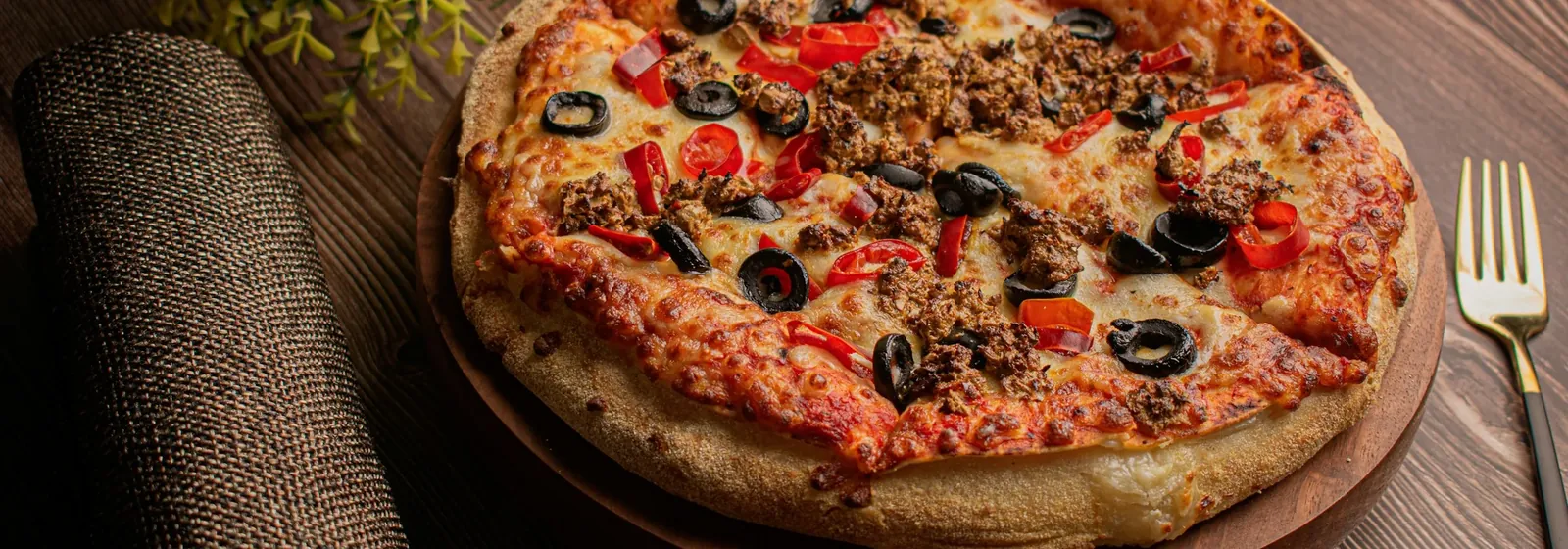 A pizza served on a wooden board