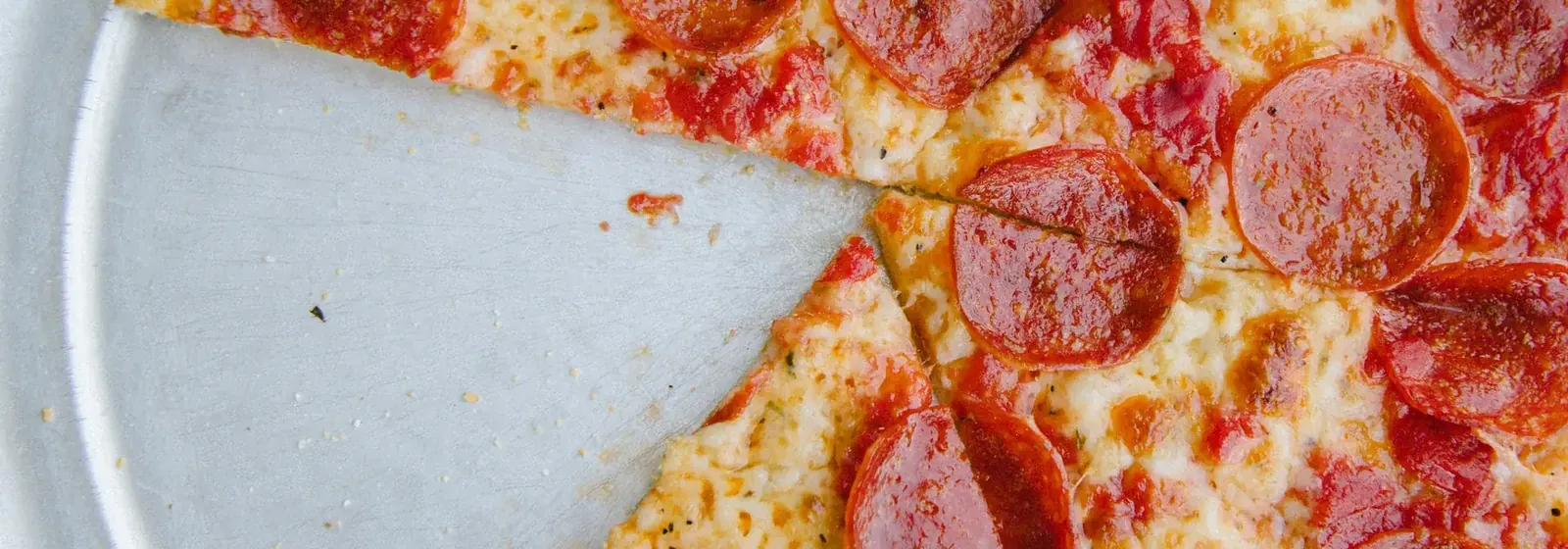 Pepperoni pizza with one slice removed