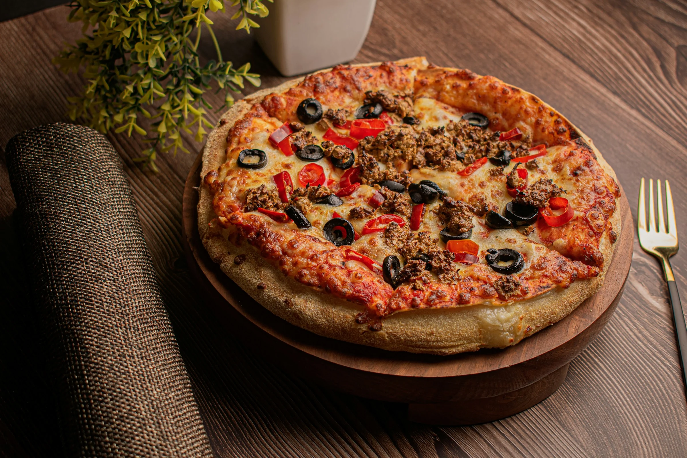 A pizza served on a wooden board